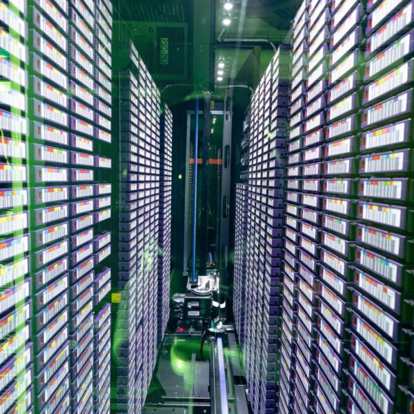 Data center with multiple rows of fully operational server racks. modern cloud computing technology concept.