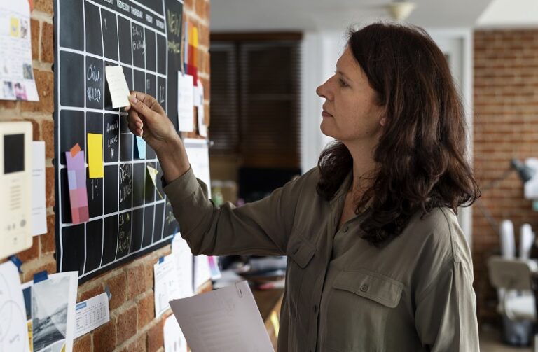 Woman pulling sticky note